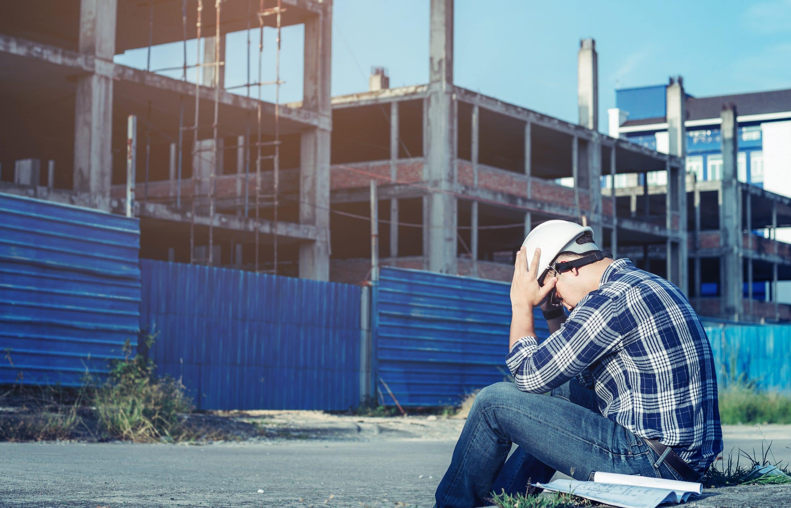 This is an image of a blue collar worker experiencing symptoms while on the job.