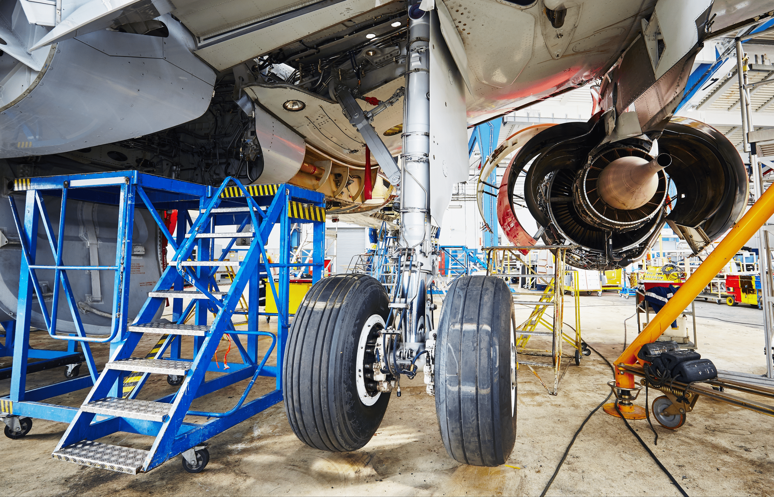 This is an image of technicians working on plane breaks - potentially being exposed to asbestos.