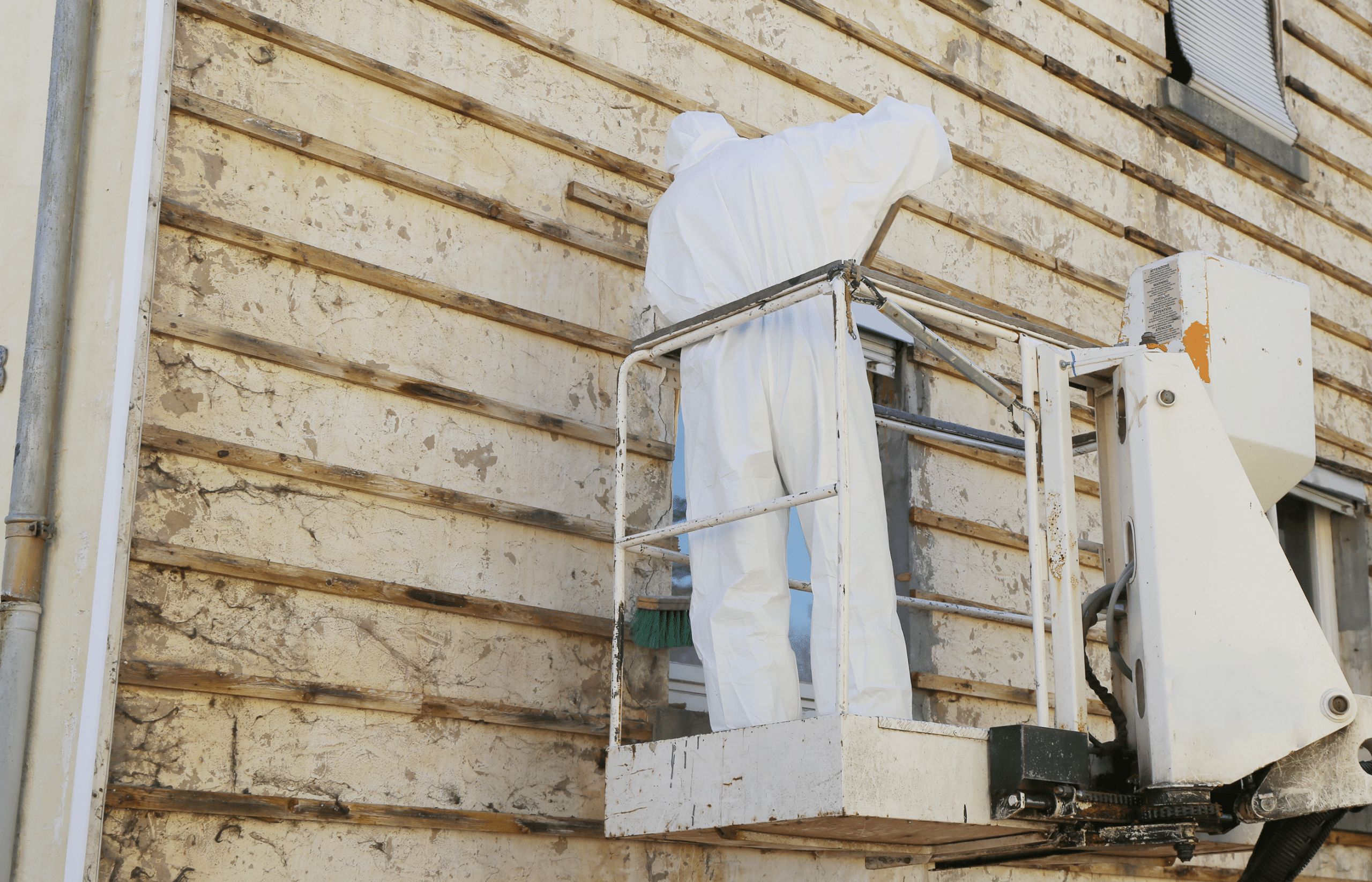 This is an image of someone removing asbestos from a building - also known as an asbestos abatement.