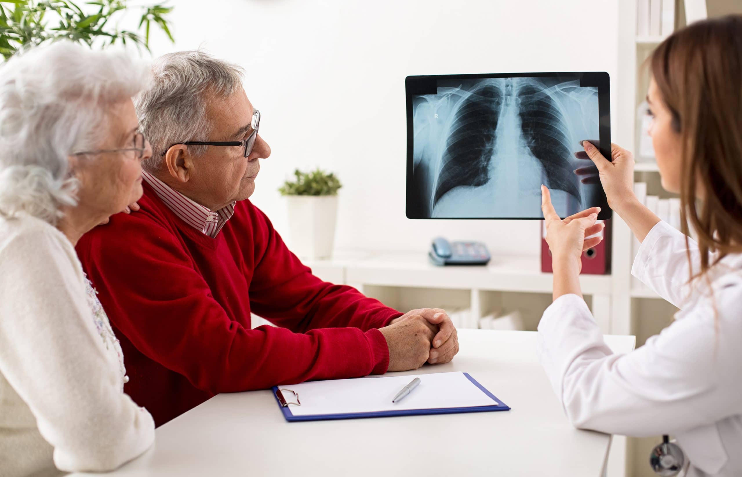 This is an image of a doctor showing a patient their pleural mesothelioma x-ray results.