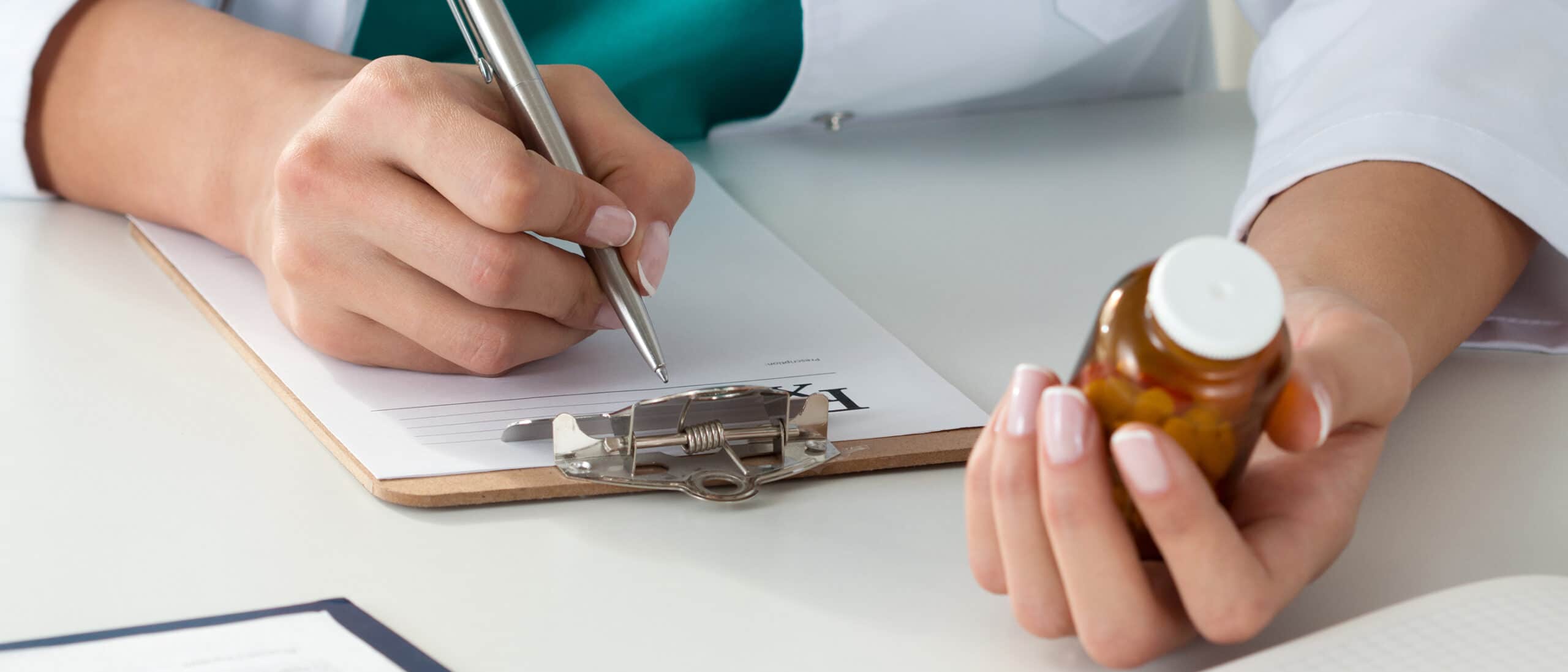 This is an image of a doctor prescribing medication to a patient.