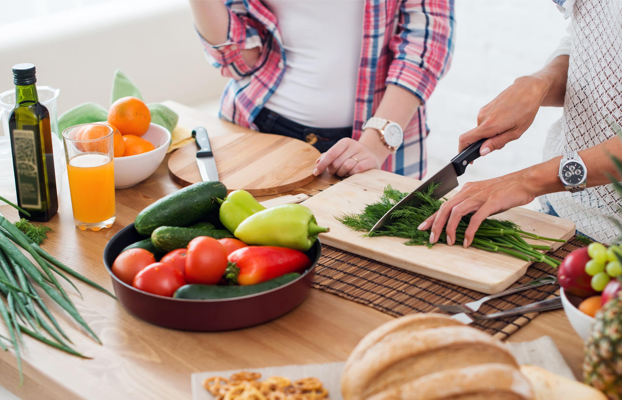 Two women preparing a healthy meal - one of many post treatment recommendations from health professionals.