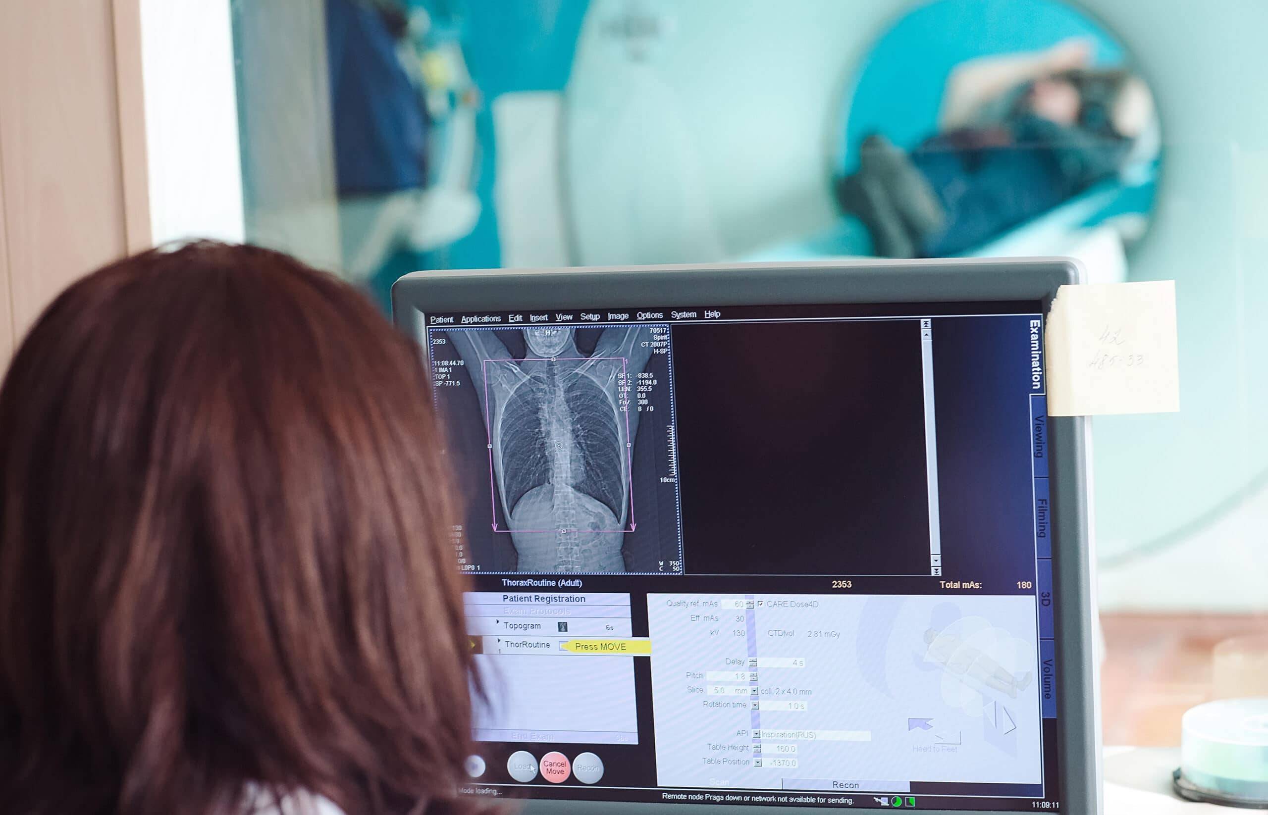 A radiation technician studying the scan imagery.