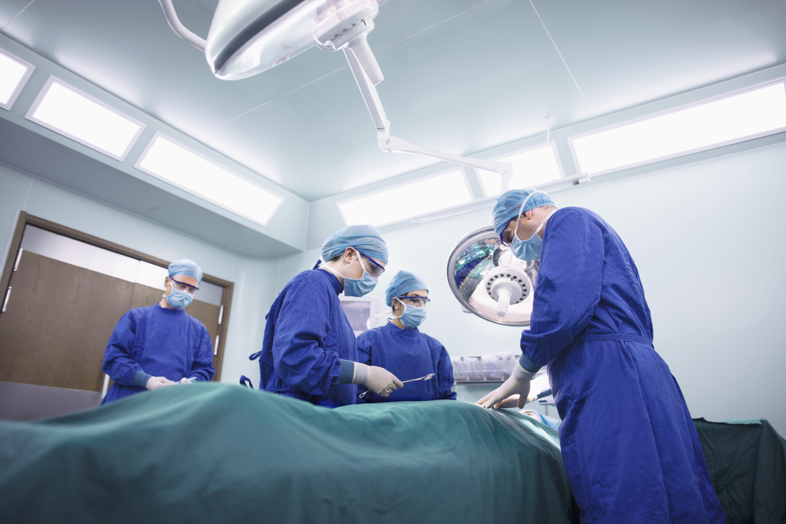 Operating room staff performing hospital surgery