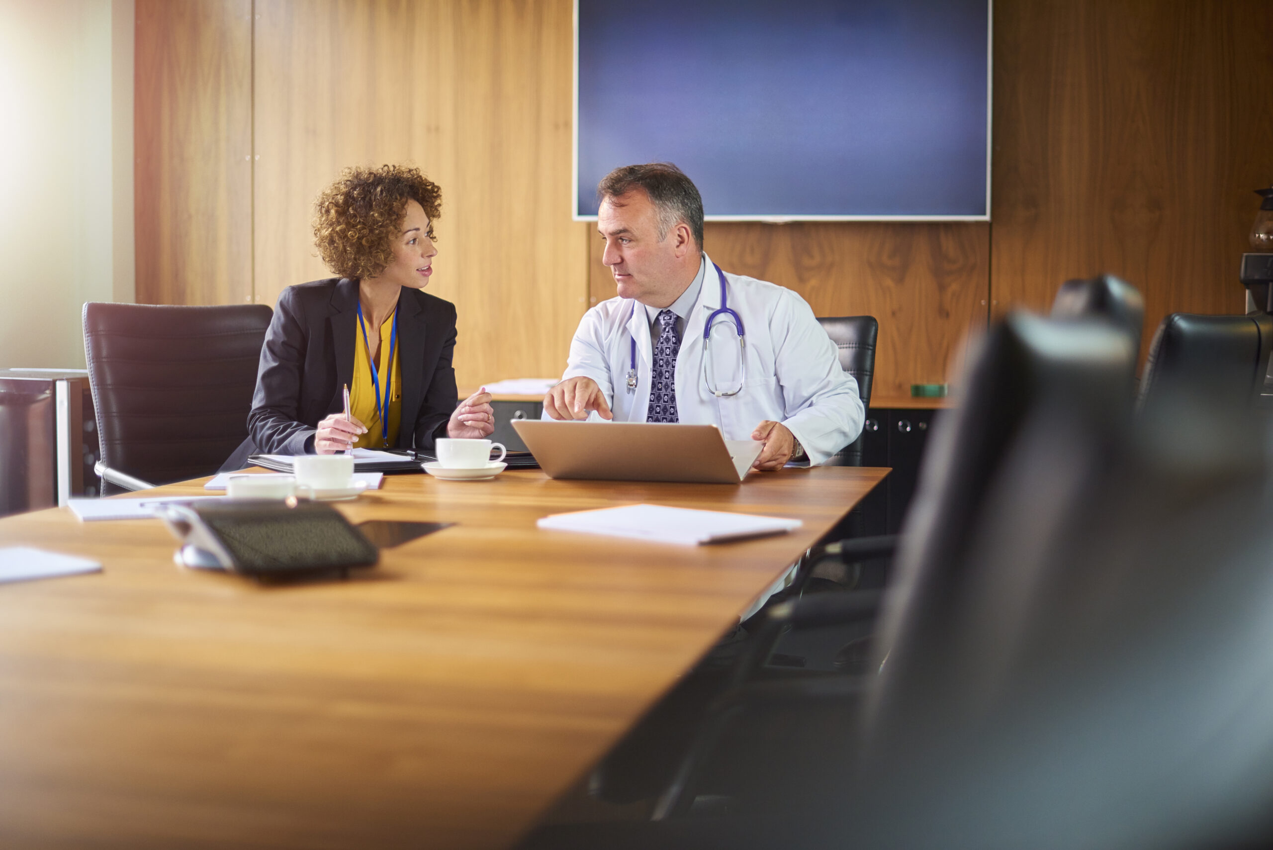 senior doctor with young female administrator