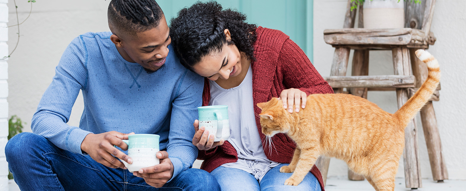 A young couple enjoying their pet.