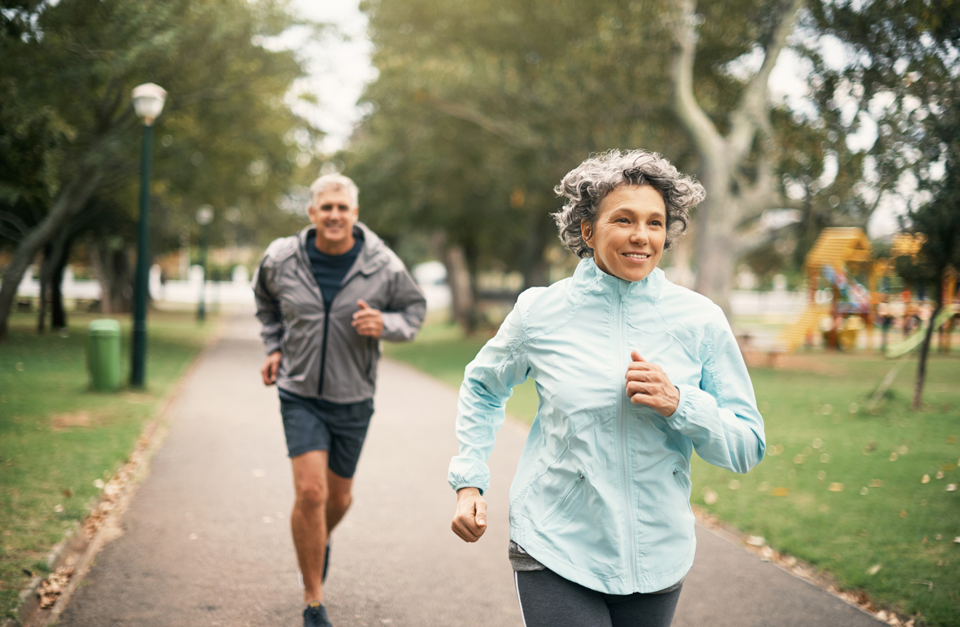 An elderly couple on a job through the park