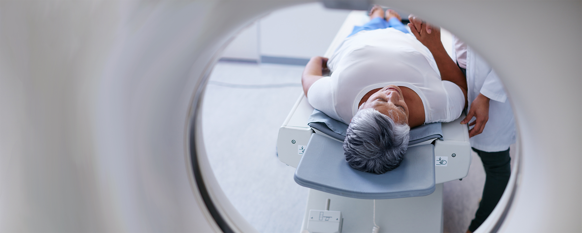 Patient receiving CT scan to help predict treatment outcome using radiomics.