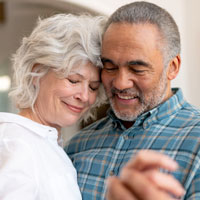 Photo of a man and woman hugging and smiling