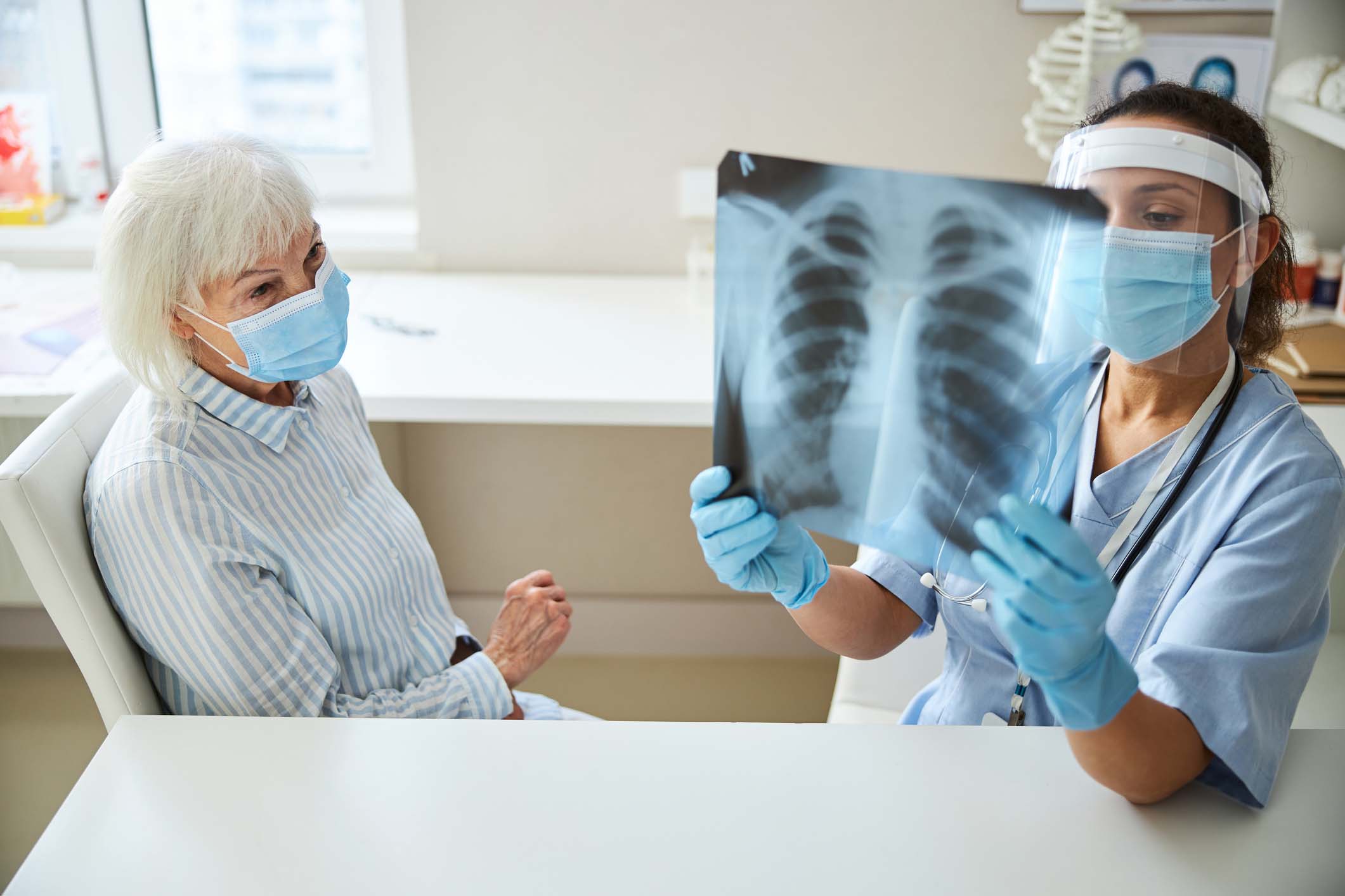 Patient and doctor reviewing xray of small cell carcinoma due to a recent diagnosis.