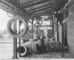 Man working with the Jeffrey Trolley Conveyor in Akron, Ohio at rubber plant