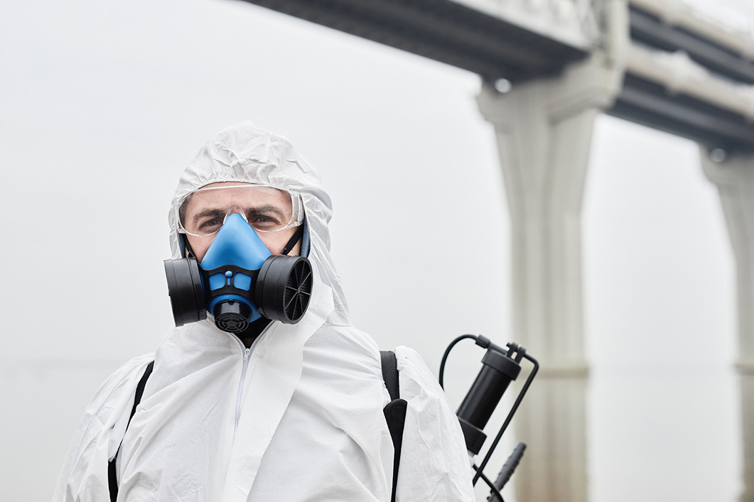 Person in hazmat suit being protected by harmful VOCs which surround them.