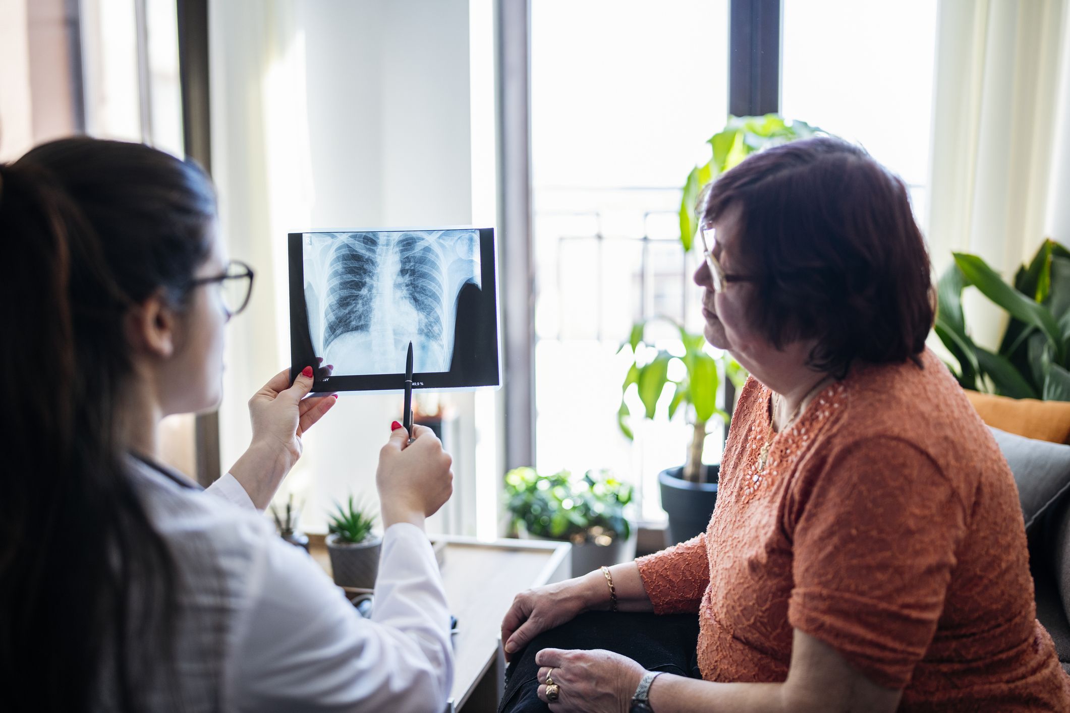A doctor showing their patient an xray of stage 1 mesothelioma.