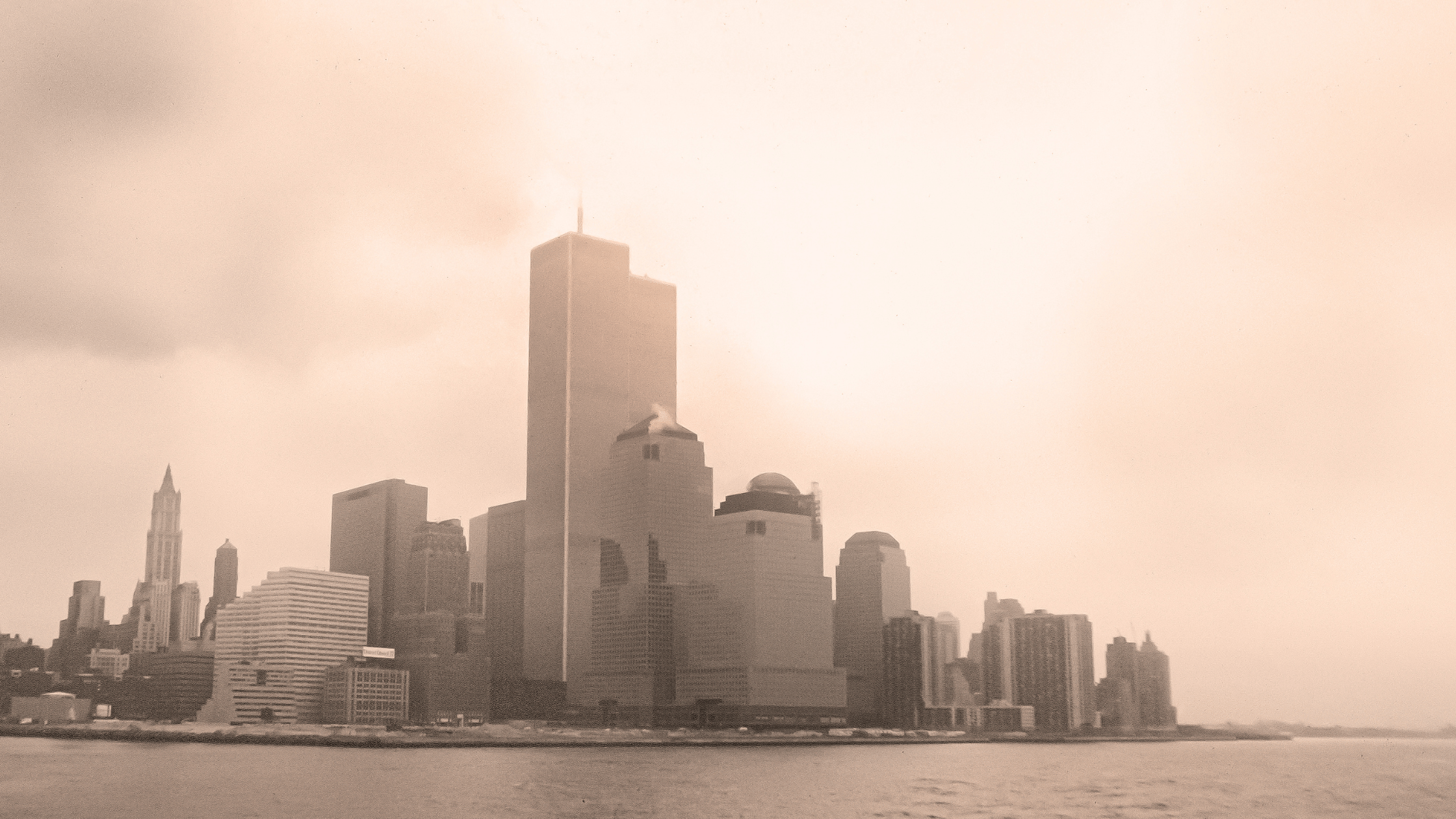 9/11 asbestos exposure from the attack on the twin towers. The towers surrounded by dust cloud.