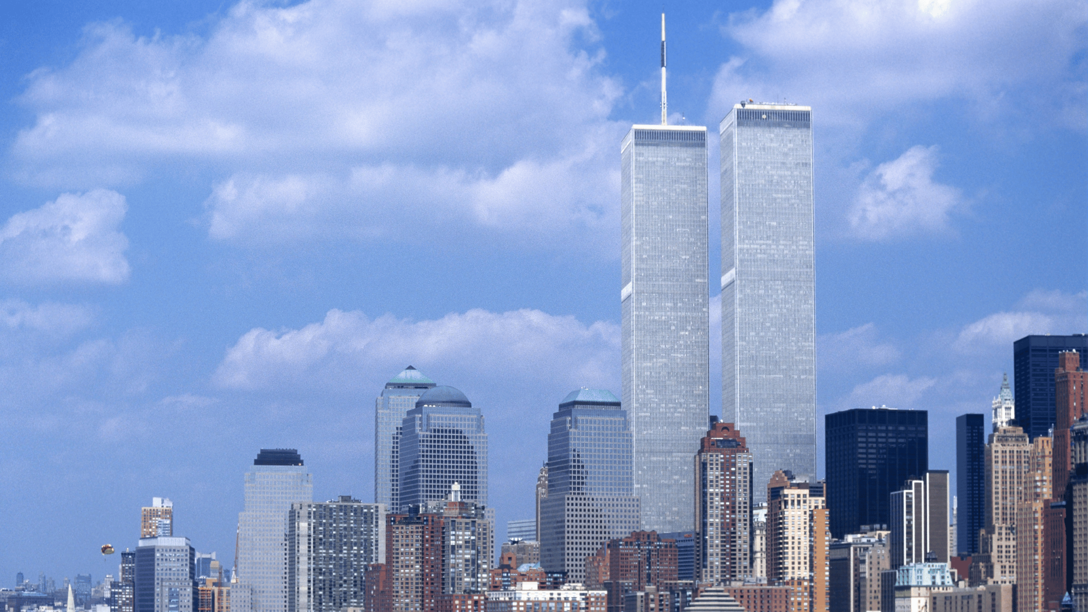 Photograph of the World Trade Center towers in New York City on a sunny day.