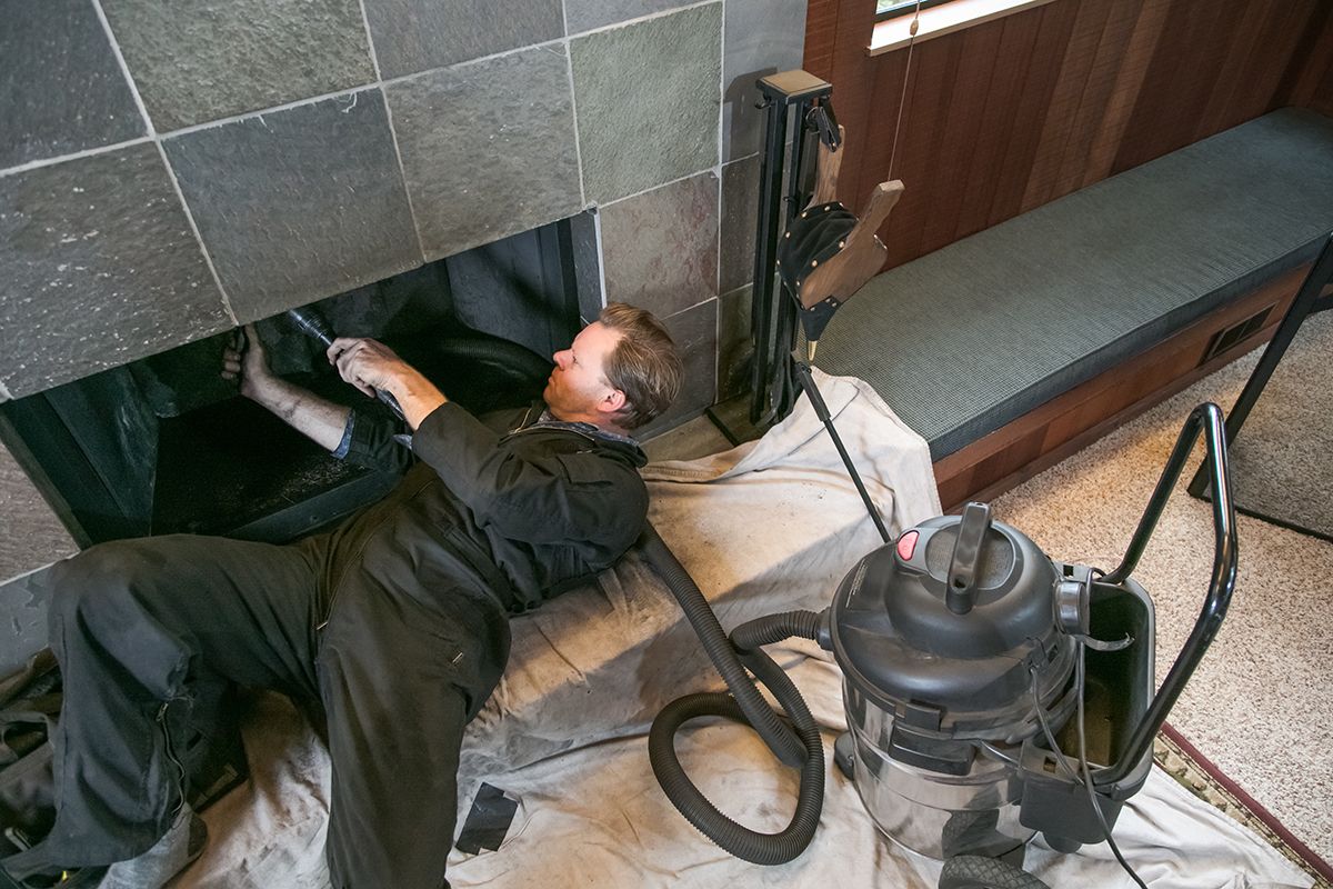 A chimney sweep working under a chimney