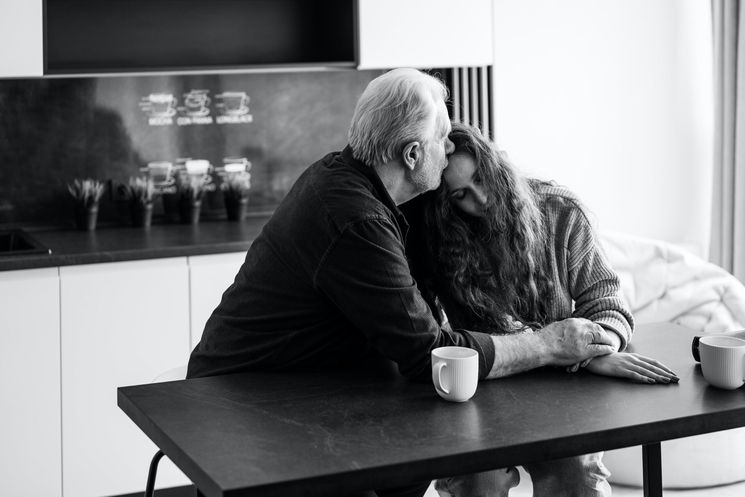 Elderly couple holding each other and expressing their deelings to one another during one of their emotional stage.