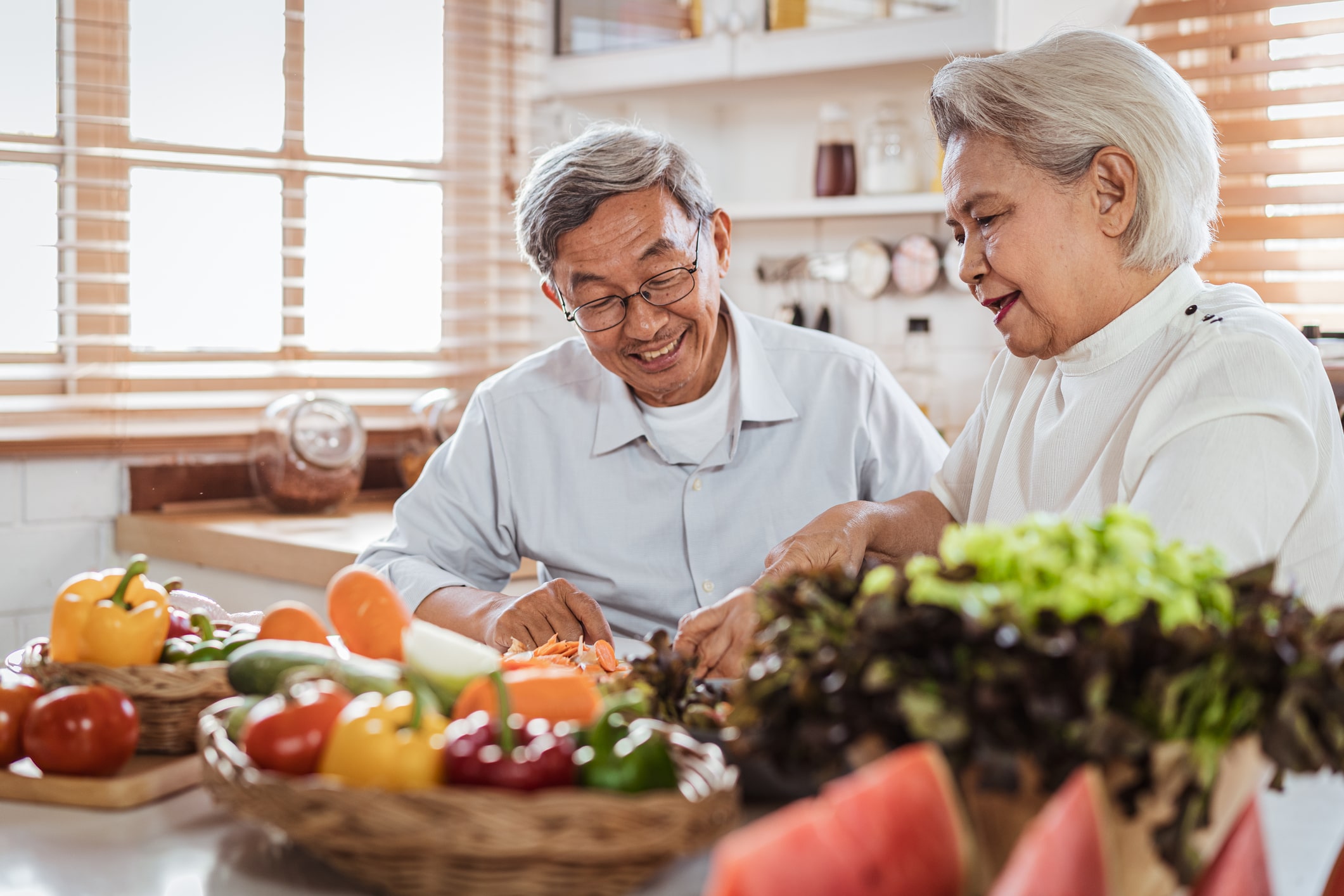 Senior Asian couple cooking a lung cancer diet together in the kitchen