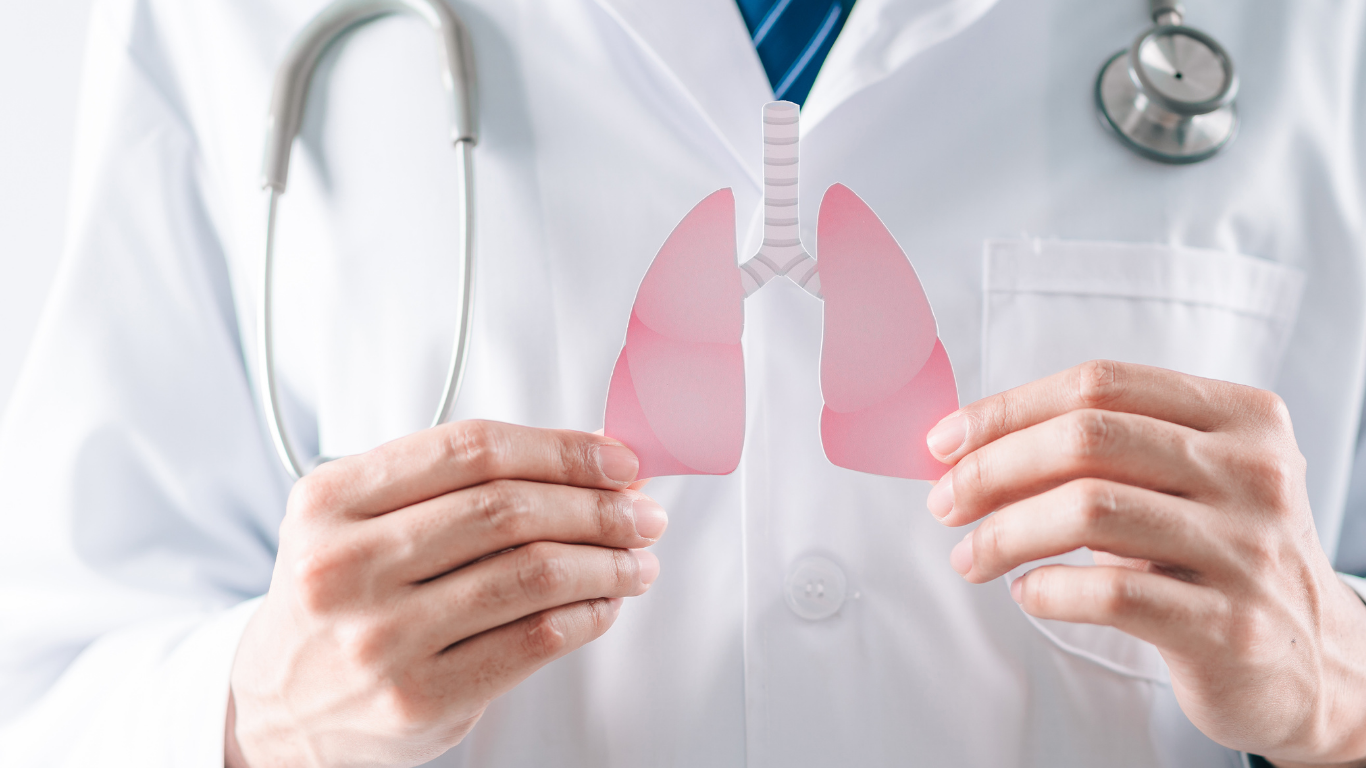 Genprex Reqorsa Researcher holding a clear lungs diagram.