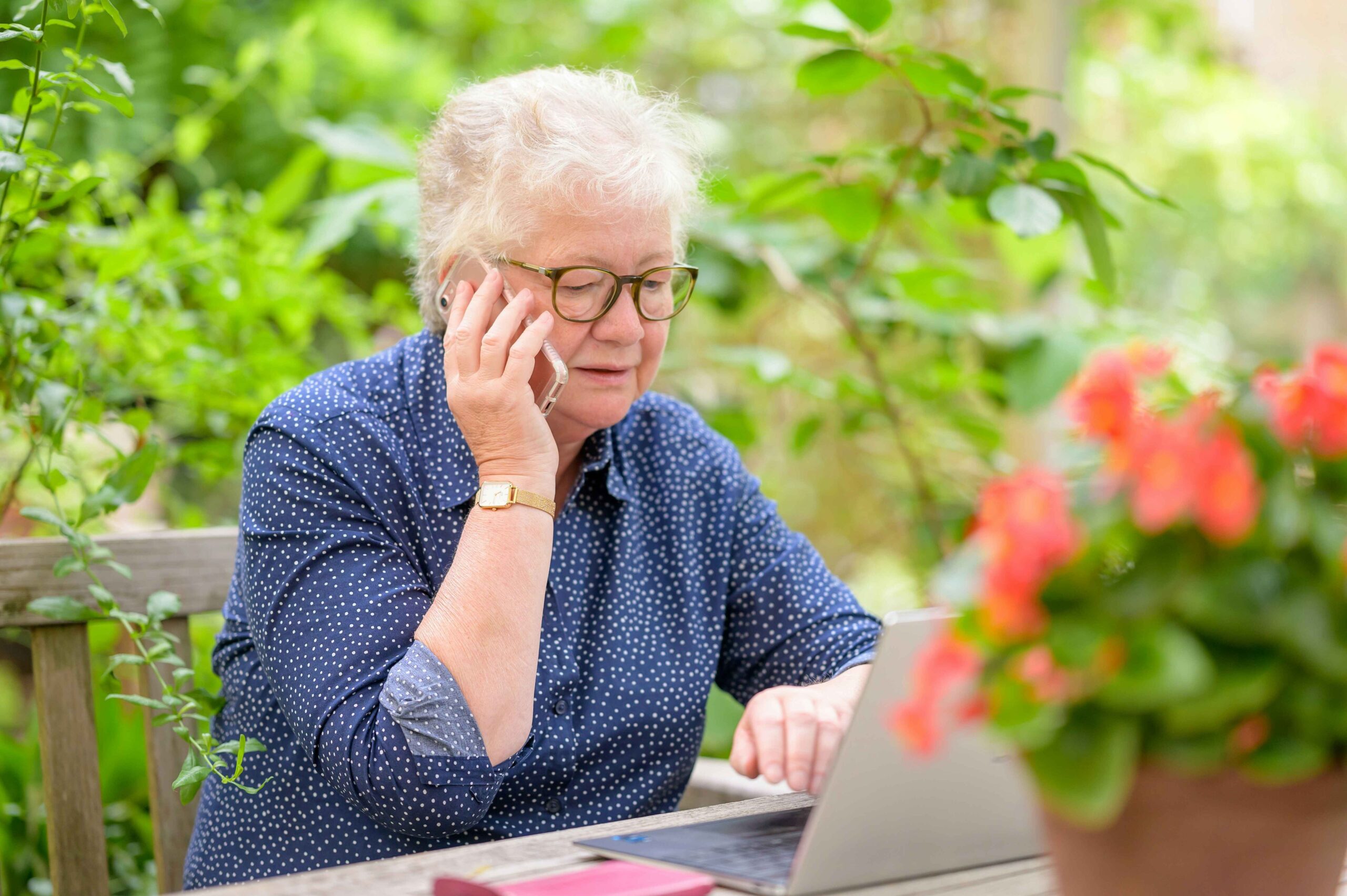 Person typing on laptop while reviewing asbestos lung cancer lawsuit paperwork and legal research